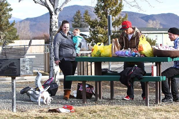 The Ramirez family and their friend Daniel Parsons, right, enjoy a bbq picnic Thursday at James Lee Memorial Park in Indian Hills on an unusually warm January day.