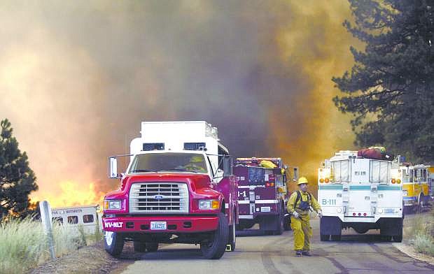 Fire crews scramble to get out of Kings Canyon after the Waterfall fire took off in 2004, destroying several fire trucks and homes in the area.