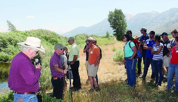 Mike Hayes of the Carson Valley Conservation District fields questions from tour participants along the bank of the Carson River Wednesday.