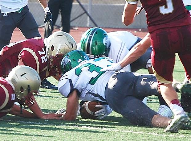 Fallon&#039;s Riley Williams (33) recovers a fumble by Cardinal Newman during Saturday&#039;s 56-32 loss.