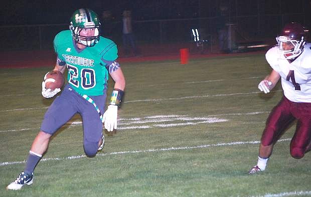 Fallon wide receiver Tyler Bagby races past an Elko defender for a 70-yard touchdown during the Greenwave&#039;s 48-20 win Friday at the Edward Arciniega Complex.