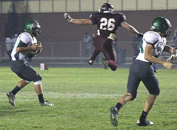 Fallon quarterback Joe Pyle gets Elko&#039;s Jacob Pengally in the air with the pump fake during the Wave&#039;s 25-14 win on Friday.