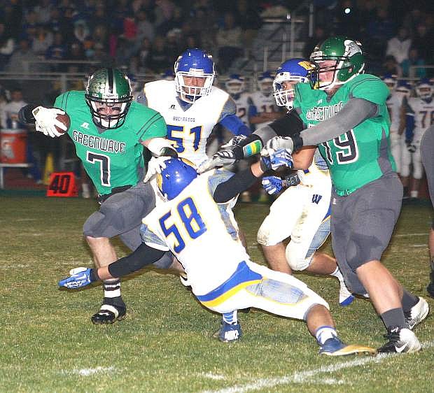 Fallon running back Trent Tarner attempts to avoid a Lowry defender as lineman Brennan Lewis blocks during Friday&#039;s 21-14 loss.