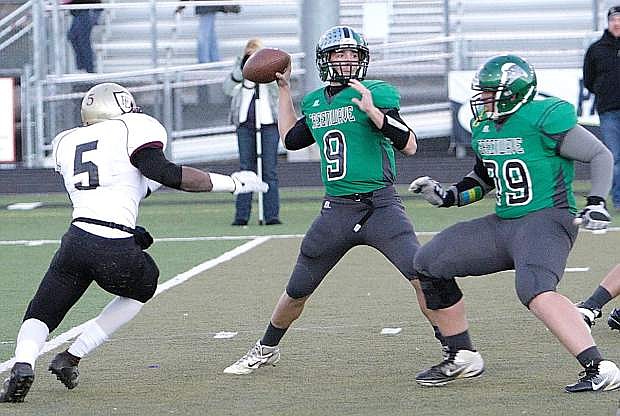 Fallon quarterback Morgan Dirickson prepares to throw as lineman Brennan Lewis looks to block Faith Lutheran&#039;s Danny Otuwa during the 2013 Division I-A title game.