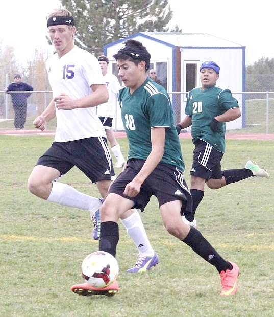 Fallon midfielder Mario Ugalde dribbles past a Spring Creek defender during Tuesday&#039;s 1-1 tie at Lowry High School. The Greenwave face Truckee at 1 p.m. today in the first round of the Northern Division I-A playoffs.