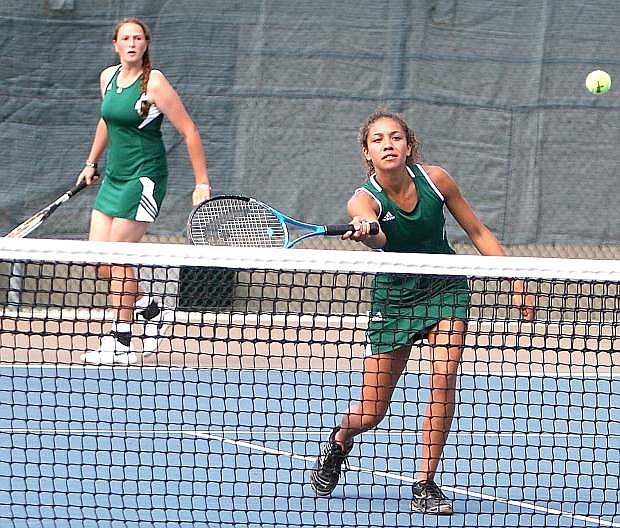 Fallon&#039;s Josie Bekiares, right, returns a shot while doubles partner Hannah Lindsay looks on during their match against South Tahoe last week.