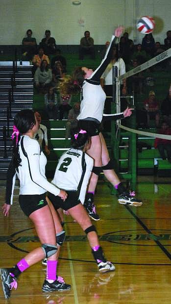 Fallon&#039;s Evan Matheson, right, spikes the ball during a match this season as Taylor Amezquita (2) and Ali Tedford, left, look on. The Lady Wave beat South Tahoe in five sets on Saturday.
