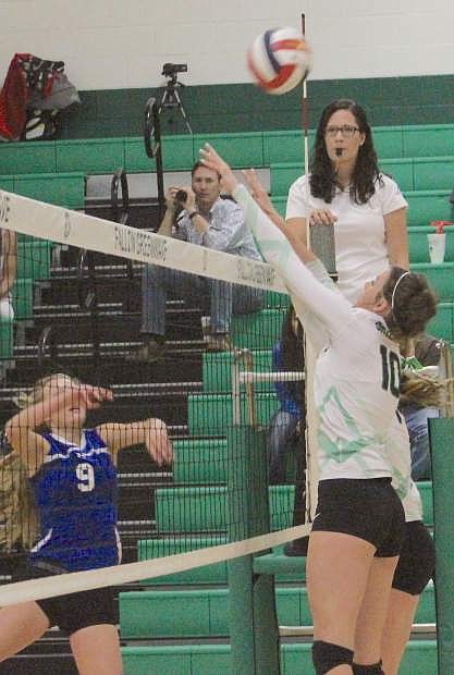 Haylee Paladini of Fallon, right, leaps to block a shot against Lowry.