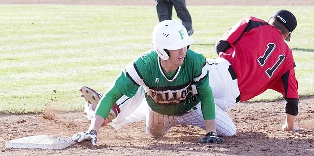 Fallon&#039;s Cameron Beyer retreats back to first as the ball skirts by Wooster&#039;s Robert Gordon.