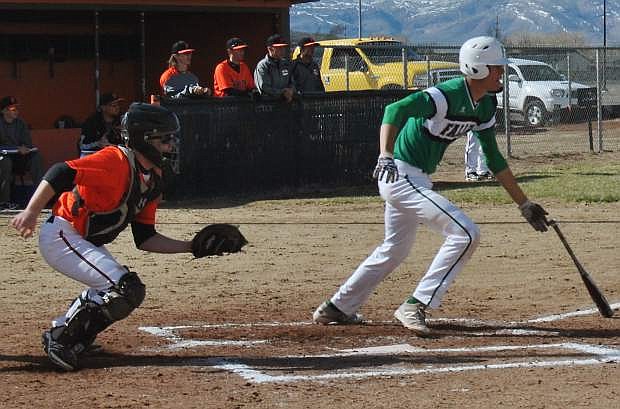 Fallon&#039;s Clay Davison begins running to first before the ball would be caught by Fernley&#039;s right fielder.