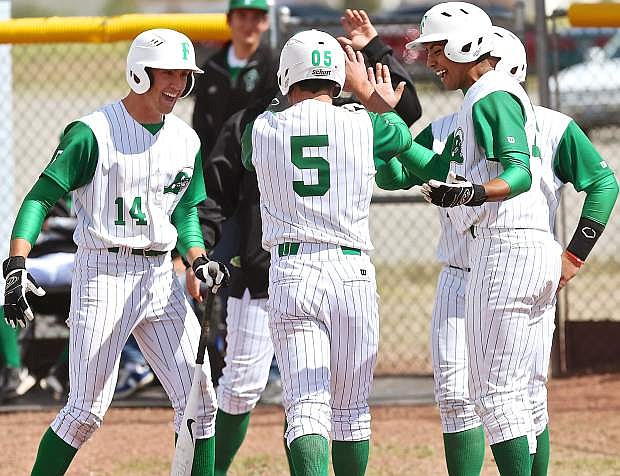 The Wave&#039;s Brock Uptain (5) is greeted at the mound by Fallon after hitting his and Fallon&#039;s first long ball of the season.