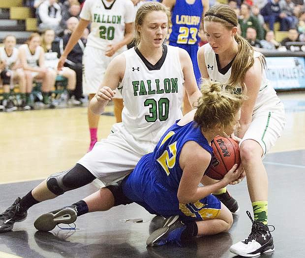 Fallon&#039;s Faith Cornmesser (30) and Caitlyn Welch (right) battle with Lowry&#039;s Brooklyn Backus in the Northern Division I-A championship game Saturday afternoon at North Valleys High School in Reno.