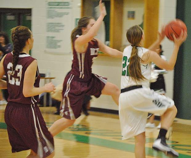 Fallon&#039;s Caitlyn Welch, 22, scores a lay-up against two Dayton guards.