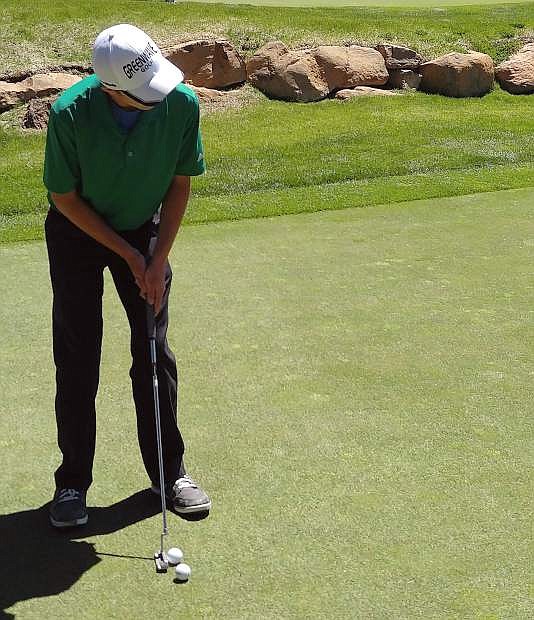 Fallon&#039;s Chance Wood bends to put on the green in the Wave&#039;s meet at Truckee on Wednesday.