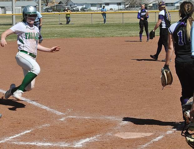 Fallon&#039;s Kayla Buckmaster slides safe into home after an RBI.