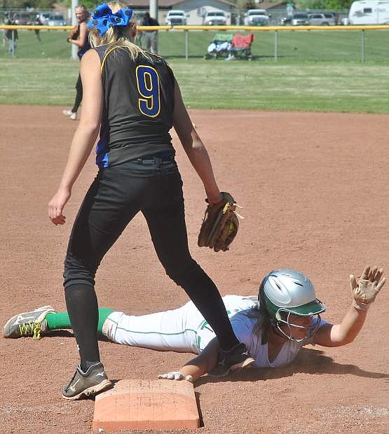 Fallon&#039;s Megan McCormick, white, dives safe back to first before Lowry&#039;s Allana Miller gets the tag.