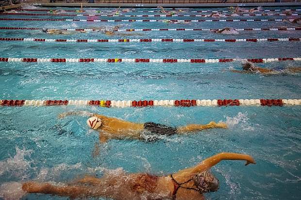 Swimmers warm up during Nevada High School State Championship swim meet at the Buchanan Natatorium on the UNLV Campus in Las Vegas on Saturday, May 21, 2016.