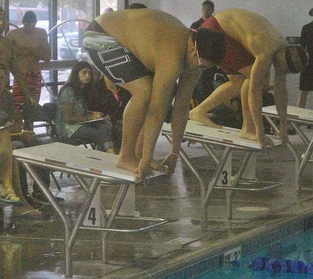 The Wave&#039;s Kobe Abe, left, prepares to take off in the 100-yard freestyle.