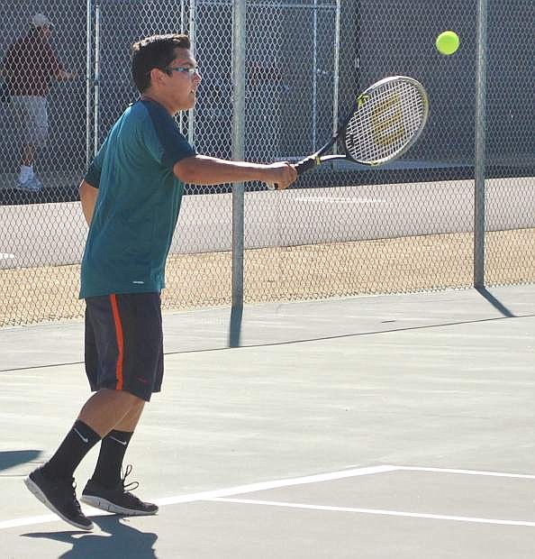 Wave tennis player Ryan Lords returns a serve in the match against Truckee on Thursday.