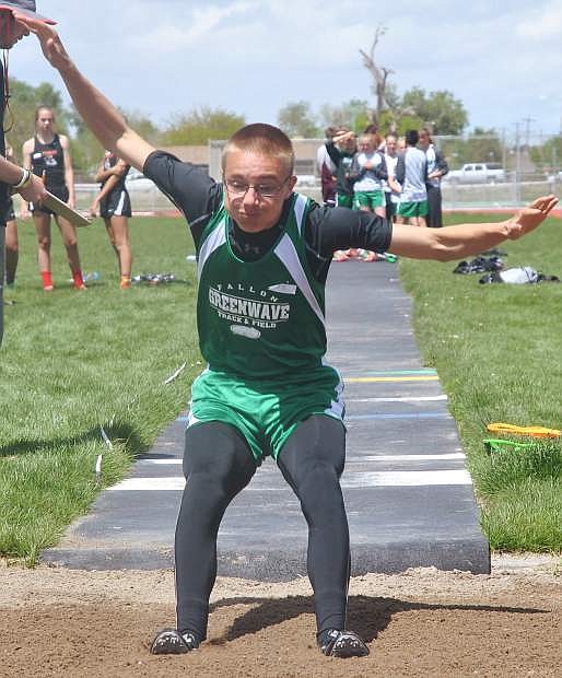 Fallon&#039;s Trevor East, a freshman for the Greenwave boys track and field team, competes in the long jump.