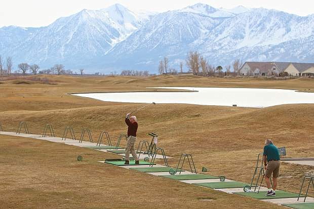 Stating that it was too warm to ski, Australian visitors Ian Davies and Reg Pugh decided to forego the slopes in favor of the links Thursday afternoon at the Sunridge Golf Course. Temperatures climbed into the low 60&#039;s this week.