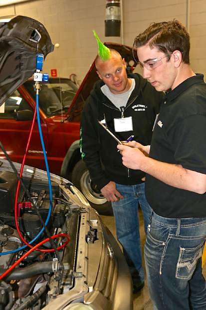 Judge Timothy Hinkle watches over Spanish Springs student Jacob Elsberry during the SkillsUSA auto competition Thursday at WNC.