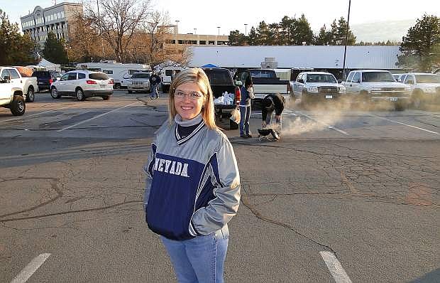 Wendy Kwapich-Mossi (Vincent), a sports enthusiast who loved football, flashes a wide grin while wearing her University of Nevada jacket during pregame festivities at Mackay Stadium.
