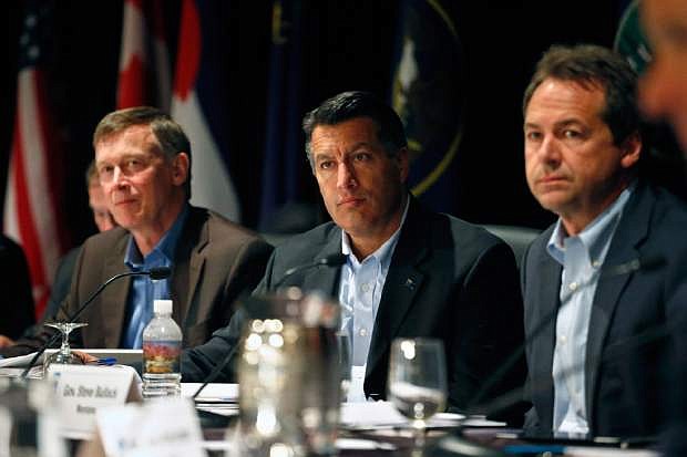 Colorado Gov. John Hickenlooper, left, Nevada Gov. Brian Sandoval, center, and Montana Gov. Steve Bullock participate in a roundtable discussion titled The Impacts of Major Western Oil and Gas Finds: Meeting Challenges and Capturing Opportunities, during the annual Western Governors&#039; Association Meeting, at the Broadmoor Hotel in Colorado Springs, Tuesday, June 10, 2014. Ten governors from Western states attended the second day of the conference Tuesday, discussing common regional issues. (AP Photo/Brennan Linsley)