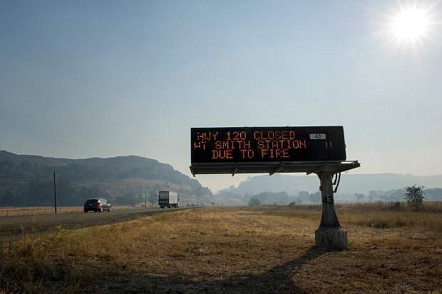 In this Tuesday, Aug. 20, 2013, a road sign warns of the closure of HWY120 on HWY108 due to the Rim Fire in the Stanislaus National Forest. Calif. The remote blaze in Stanislaus National Forest west of Yosemite grew to more than 25 square miles Wednesday, and was only 5 percent contained, threatening homes, hotels and camp buildings.(AP Photo/The Modesto Bee, Andy Alfaro) LOCAL TV OUT (KXTV10, KCRA3, KOVR13, FOX40, KMAX31, KQCA58, CENTRAL VALLEY TV); LOCAL PRINT OUT (TURLOCK JOURNAL, CERES COURIER, OAKDALE LEADER, MODESTO VIEW, PATTERSON IRRIGATOR, MANTECA BULLETIN, RIPON, RECROD, SONORA UNION DEMOCRAT, AMADOR LEDGER DISPATCH, ESCALON TIMES, CALAVERAS ENTERPRISE, RIVERBANKS NEWS) LOCAL INTERNET OUT (TURLOCK CITY NEWS.COM, MOTHER LODE.COM)