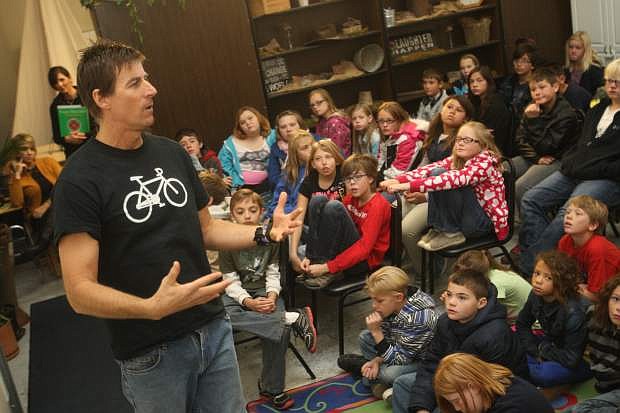 Photographer and cyclist Rick Gunn talks to students at Carson Montessori School in mid November about his Wheels for Peace program and how he would like to get them involved.