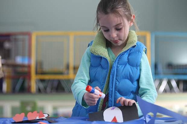 Five-year-old Trella Springman makes a penguin out of construction paper at the Children&#039;s Museum of Northern Nevada on Saturday during the arts and crafts winter celebration.