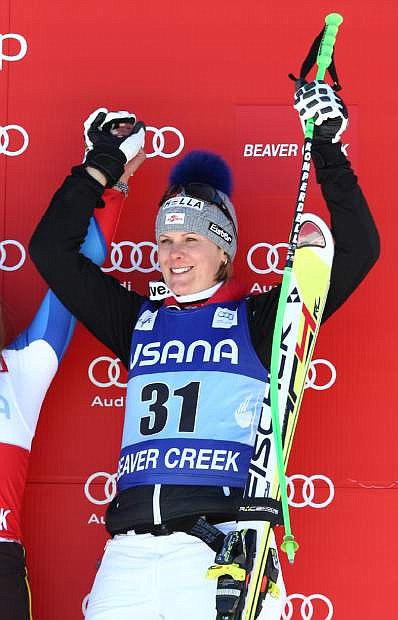 Austria&#039;s Nicole Hosp raises her hand on the podium after taking third place in the women&#039;s World Cup super-G skiing event, in Beaver Creek, Colo., Saturday, Nov. 30, 2013. (AP Photo/Allesandro Trovati)