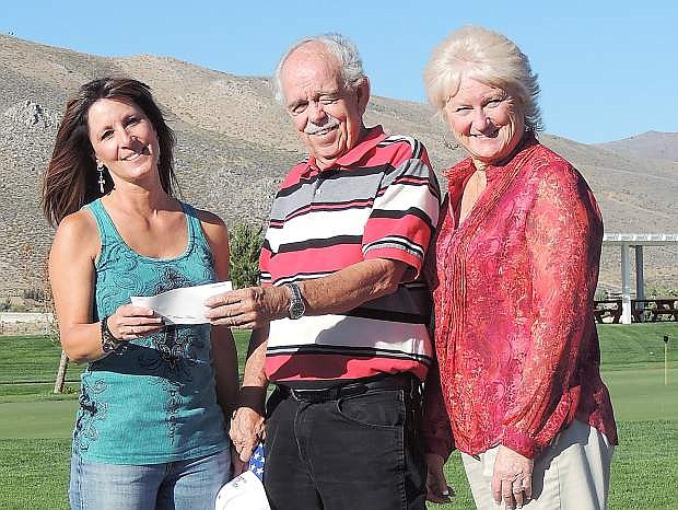 Tina Luce, liaison for Wounded Warriors and tournament director for a recent golf tournament and dinner to raise funds accepts funds from Garth Richards, middle, of Silver Oak Golf Course and Executive Conference Center, and Terrie McNutt, Silver Oak general manager, on the right. The check actually represents more than $100,000 raised at events over time. The money benefits families of the 26 Nevadans killed in Iraq and Afghanistan, Honor Flights and Wounded Warrior. Silver Oak owners are Garth and Sean Richards, and Mark Turner.