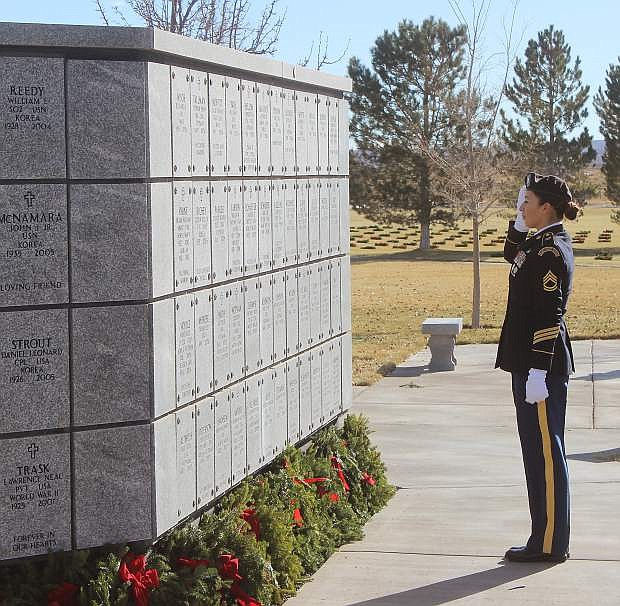Sgt. First Class Mayra Serrano of the Nevada Army National Guard salutes after placing a wreath at the Northern Nevada Veterans Memorial Cemetery in Fernley as part of the Wreaths Across America program.