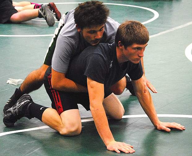 Fallon wrestlers Talon Uptain, top, and Trae Workman work on positioning during Tuesday&#039;s practice. The Greenwave host their annual Earl Wilkens/Lee Riggins Memorial Tournament today and Saturday.