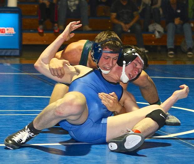 Carson 138-pounder Nathan Mersino tries to escape the grasp of Damonte&#039;s Cameron Sandoval last Wednesday night at Carson High.