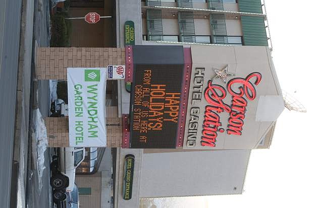 A temporary banner displays the new name Wyndham Garden Hotel at the Carson Station on Monday.