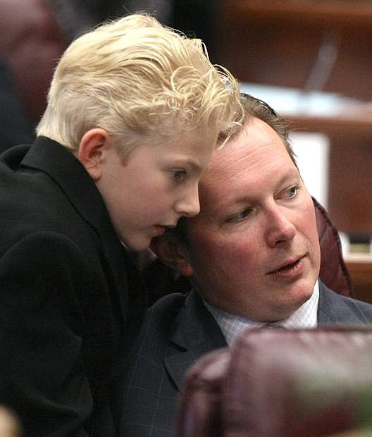 Senator Ben Kieckhefer shares a special moment in the Senate Chamber with his 8-year-old son Austin on Monday.