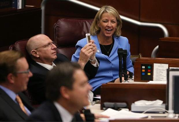 Nevada Senators Joe Hardy, R-Boulder City, and Barbara Cegavske, R-Las Vegas, react to their final vote during the second day of a special session at the Nevada Legislature, in Carson City, Nev., on Thursday, Sept. 11, 2014. Lawmakers are considering a complex deal to bring Tesla Motors to Nevada. (AP Photo/Cathleen Allison)