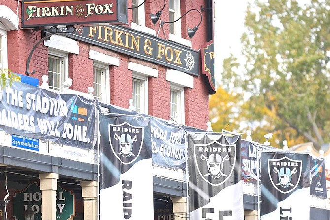 Pro-Raider banners fly outside of the Firkin &amp; Fox on Carson St. Thursday morning.