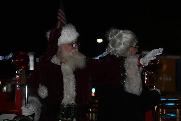 Santa and Mrs. Claus wave to visitors from the 1927 Seagrave fire engine from Warren Engine Co. during the annual Silver &amp; Snowflakes Festival of Lights on Friday.