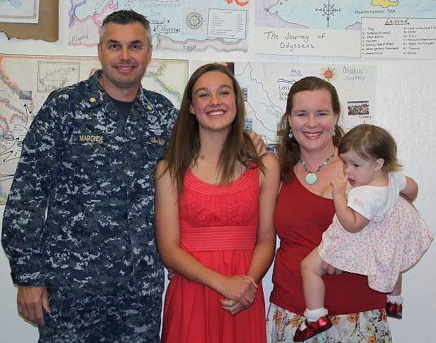 Caitlin Maronde, middle, celebrates her achievement with her dad, Lt Cdr Bradford Maronde, her mother, Brenda Maronde, and little sister, Keira.