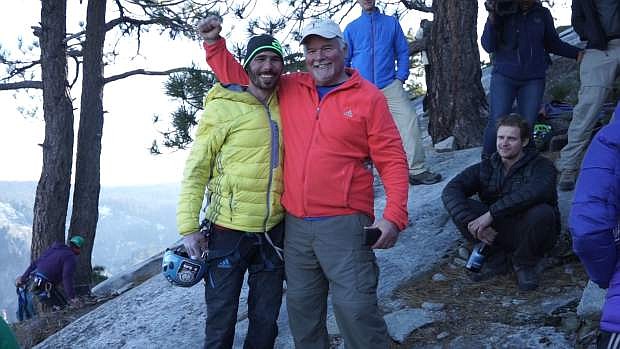 In this Wednesday, Jan. 14, 2015 photo provided by Ted Distel, Kevin Jorgeson, left, is greeted by his father Eric Jorgeson after reaching the top of El Capitan, a 3,000-foot sheer granite face in Yosemite National Park, Calif. Rock climber Tommy Caldwell was first to pull himself atop the granite face followed minutes later by his longtime friend Jorgeson. After years of practice, failed attempts and 19 grueling days scaling the vertical wall on El Capitan by their bloodied fingertips, the friends completed the first free climb up the world&#039;s largest granite monolith.  (AP Photo/Ted Distel)