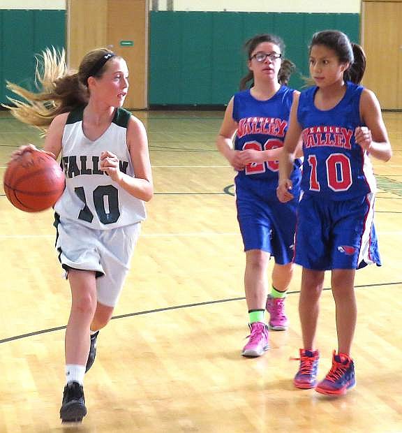 Fallon eighth-grade basketball player Kenna Hamlin drives past a pair of Eagle Valley defenders during a recent game.