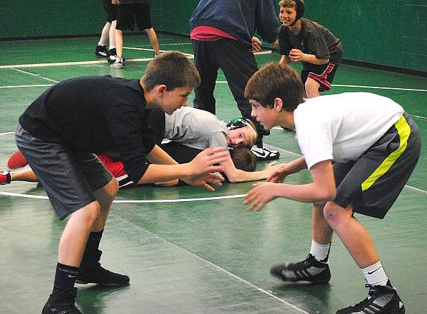 Tanner Stritenberger, left, and Talon Amezquita, work on takedown drills during practice at Churchill County Middle School on Wednesday.