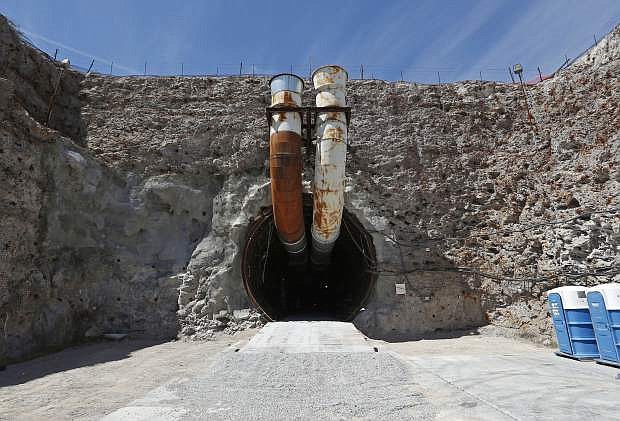FILE - This April 9, 2015, file photo shows the south portal of the proposed Yucca Mountain nuclear waste dump near Mercury, Nev. The Nevada Agency for Nuclear Projects is expected on Tuesday, May 10, 2016, to rip a 301-page environmental study completed last week by U.S. Nuclear Regulatory Commission staff members as technically and legally defective. Projections are that contaminated water could migrate beneath the Amargosa Valley farm area 80 miles northwest of Las Vegas toward Death Valley National Park in Calif. (AP Photo/John Locher, File)