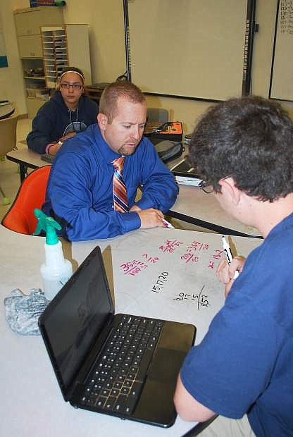 Oasis Academy math teacher Jake Lewis works on Tuesday morning with a small group of students.
