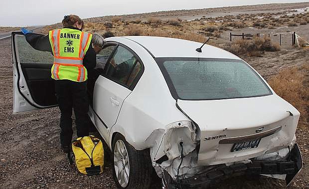 A car driven by Archie Huff was hit from behind on the Lovelock Highway. Paramedics attend to the passenger who was in the second vehicle.