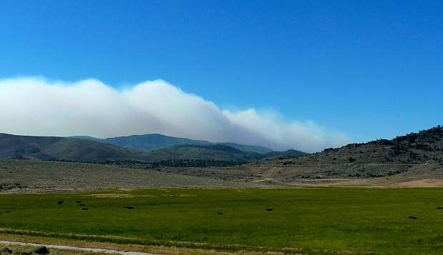Smoke rises over Diamond Valley on Sunday morning as the Washington fire continues to burn. Gusty winds have already picked up in Alpine County and are expected to continue into the night.