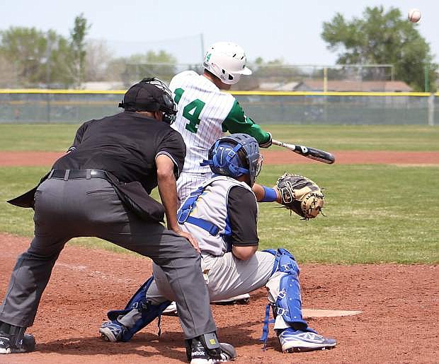 Fallon&#039;s Tristen Salazar drives the ball to outfield against Lowry as catcher Donovan Brumm and home plate umpire Rich Martinez look on in Saturday&#039;s conference clash.